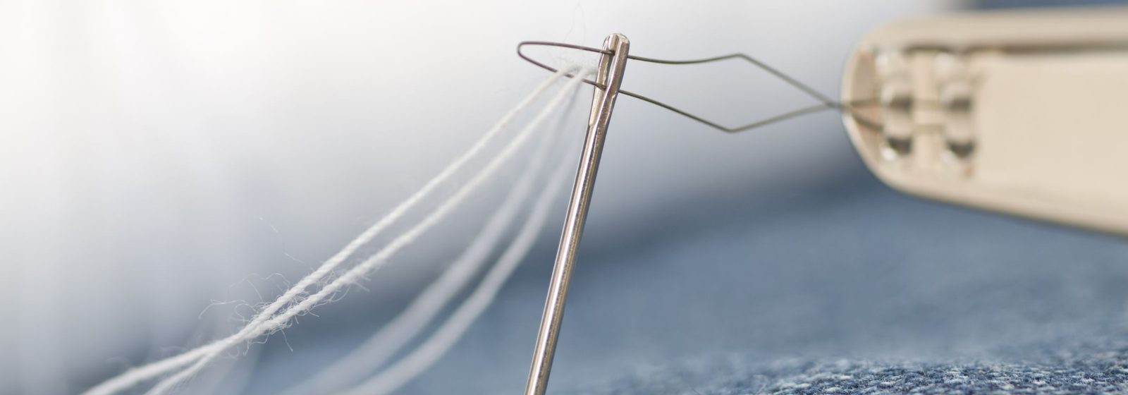 Needle and thread in denim fabric